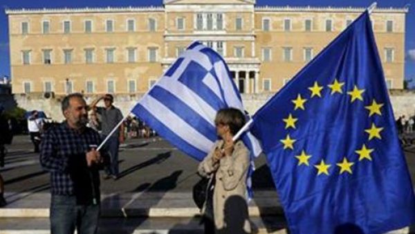 People holding Greek and EU flag